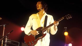 Pete Townshend, wearing his trademark white boiler suit, performs live on stage playing a Gibson SG Special guitar, with rock group The Who during the European leg of the band's Tommy Tour at a venue in England in October 1970.