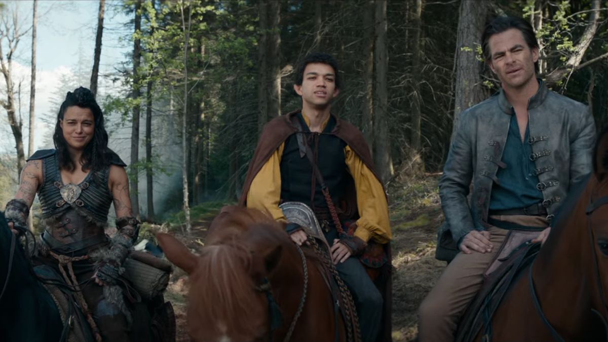 Michelle Rodriguez, Justice Smith, and Chris Pine having a conversation in the woods, on horseback in Dungeons &amp; Dragons: Honor Among Thieves.