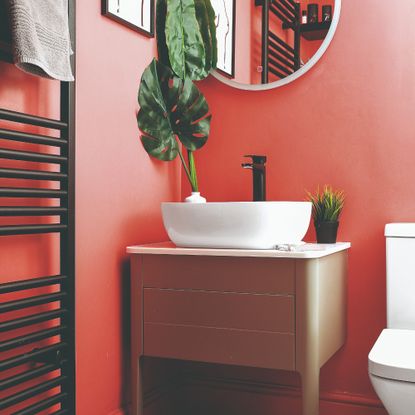 A cloakroom painted in coral pink