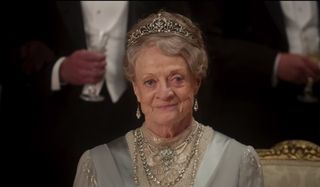 Downton Abbey Violet the Dowager Countess smiles while in her finery