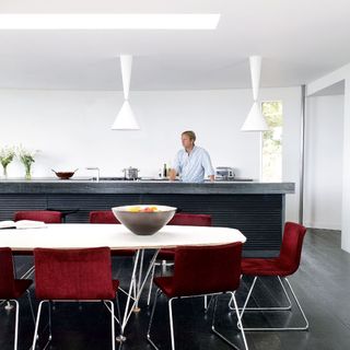 kitchen with white wall and dining table and burgundy chairs