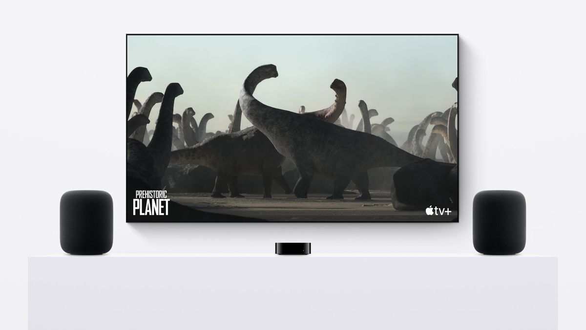 Two Apple HomePod 2 speakers on either side of a TV displaying Apple TV