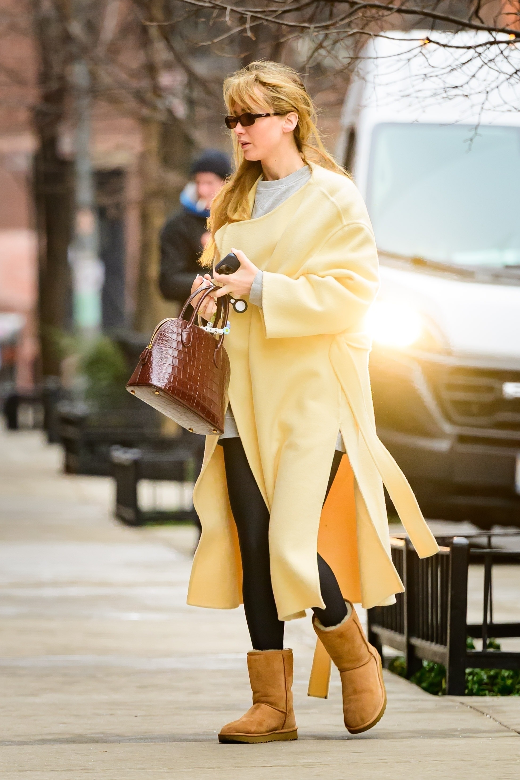 Jennifer Lawrence was spotted in a butter yellow The Row coat, black Alo leggings, Ugg boots, and The Row Lady Bag