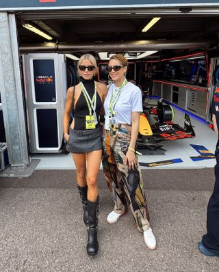 Caroline Daur at the Monaco Grand Prix in Monte Carlo wearing a halter top, miniskirt, Miu Miu moto boots, and an Hermès Kelly bag with Nathalie Emmanuel.