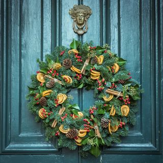 christmas wreath hanging up adorned with dried orange slices