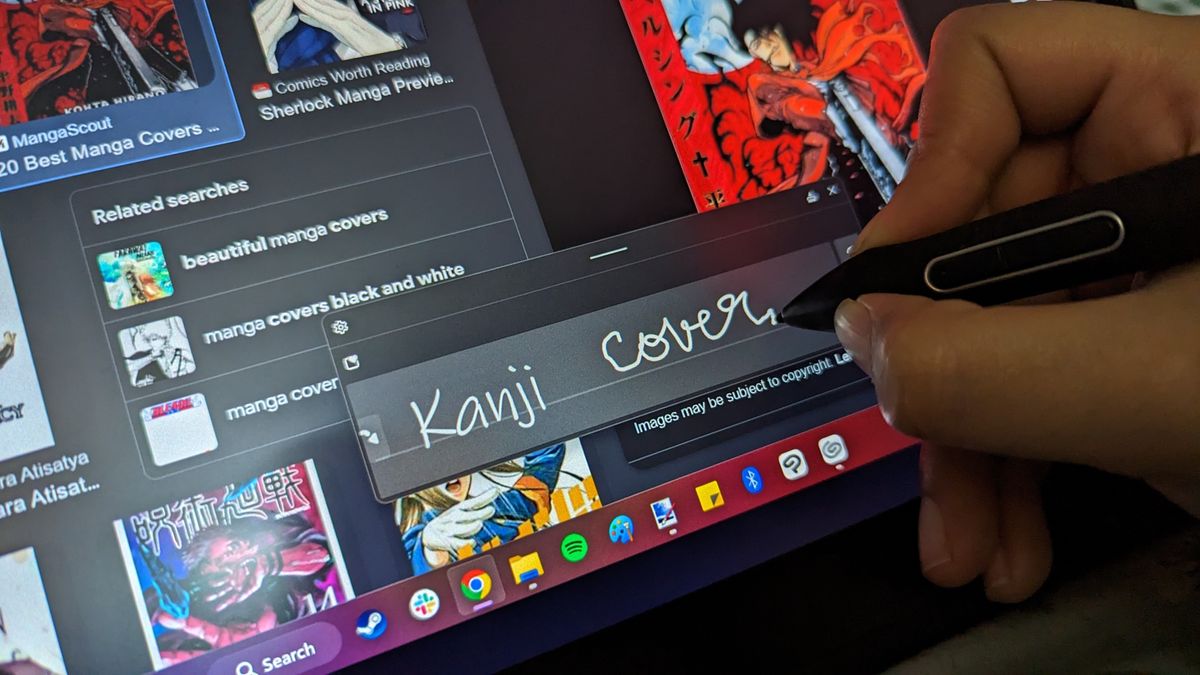 Huion Kamvas Pro 13 2.5K graphics / drawing tablet being used on a wooden table in an office space in the daytime.