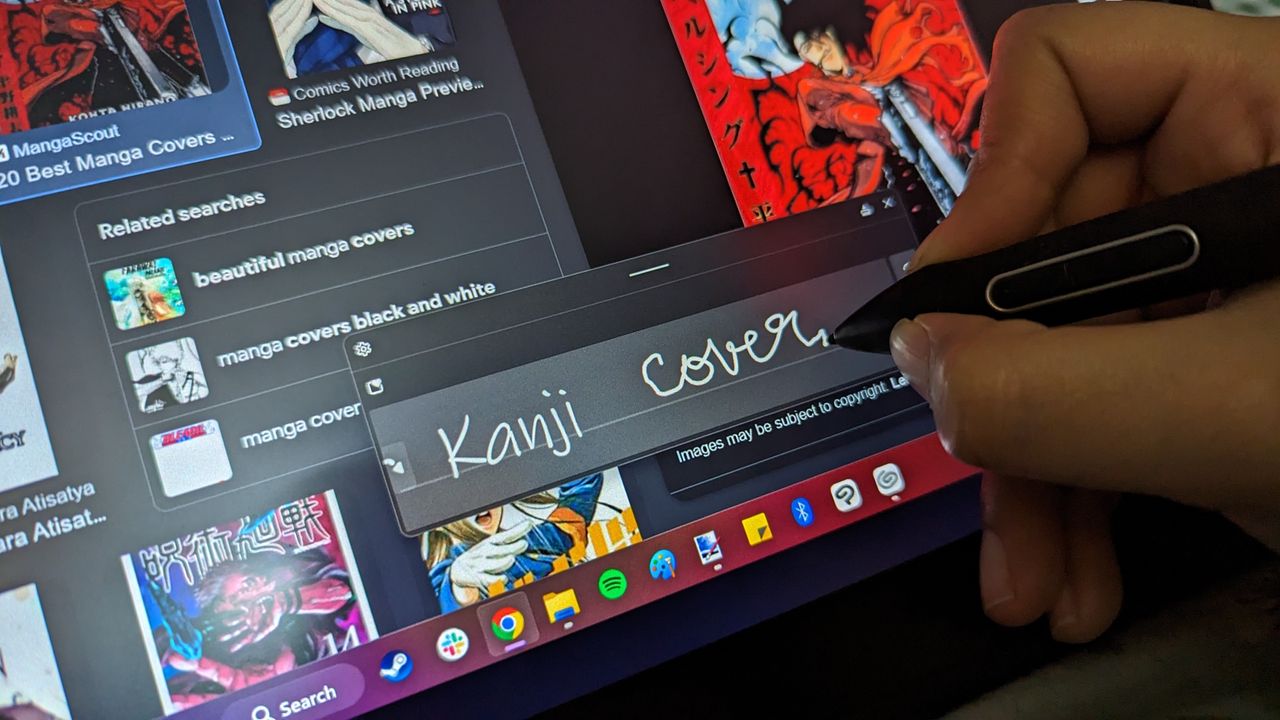 Huion Kamvas Pro 13 2.5K graphics / drawing tablet being used on a wooden table in an office space in the daytime.