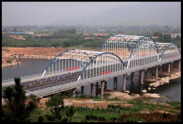 The peloton crosses the Taian Bridge.