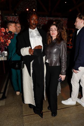 Jodie Turner-Smith in a midriff-baring white and black outfit.