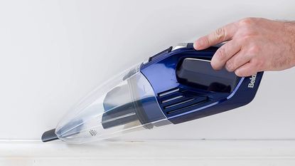 Image of Beldray Wet and Dry cordless hand vacuum during use in promotional photo in kitchen