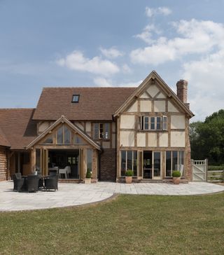 traditional oak frame home with sun room and garden patio