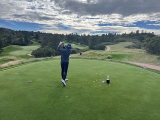 dustin jacoby hitting a tee shot on a golf course