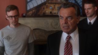 Ray Wise in the foreground wearing a suit in NCIS