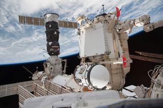 Astronauts attach the Rassvet module to the International Space Station.