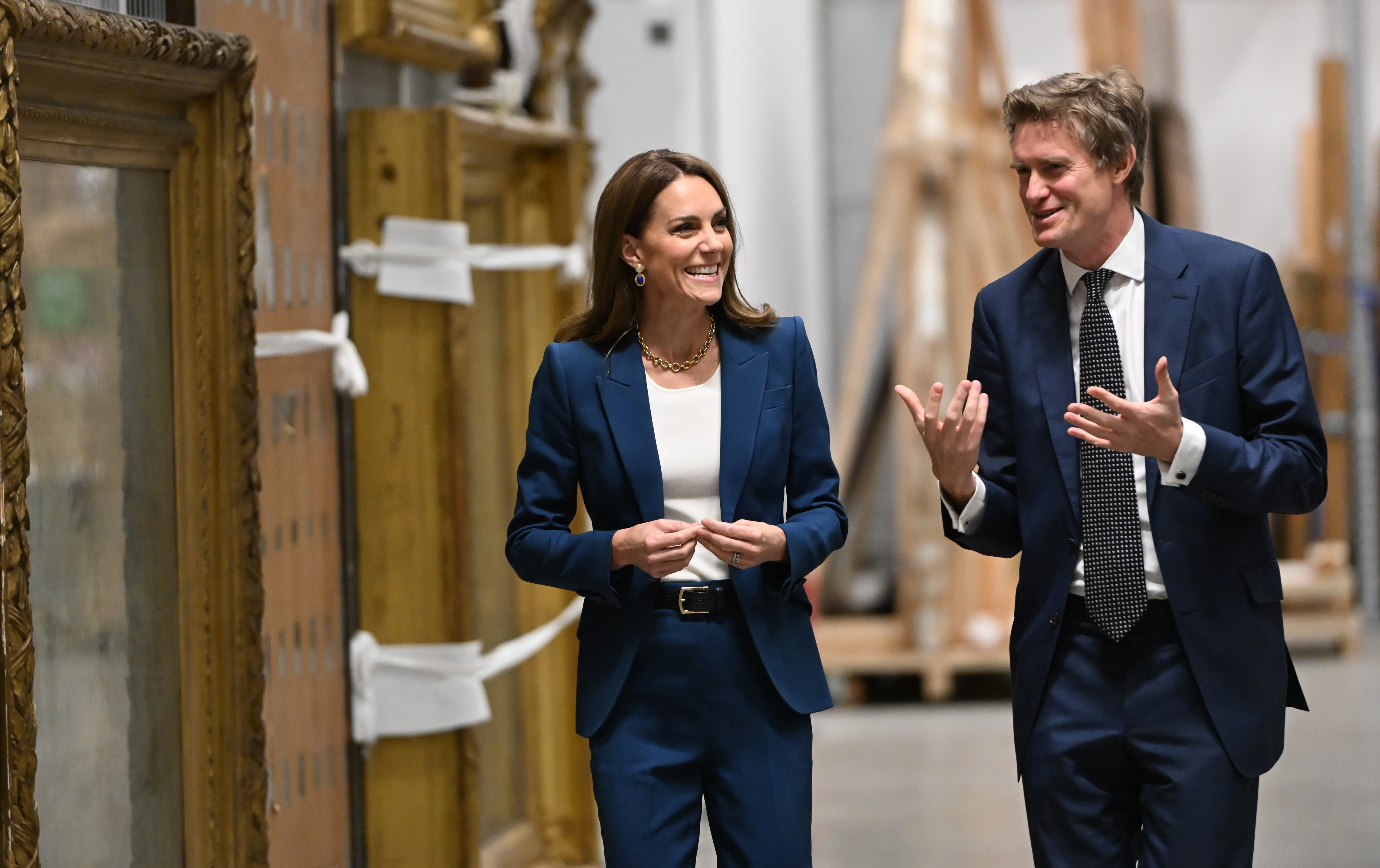 Kate Middleton wearing a blue suit talking with Tristram Hunt