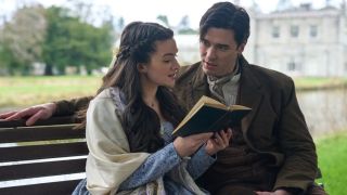 A love-struck Liam (Lachlan Quarmby) gazes into the eyes of his beloved Cora as she reads to him, both sat together on a bench in the verdant grounds of a grand Irish estate in "Providence Falls".