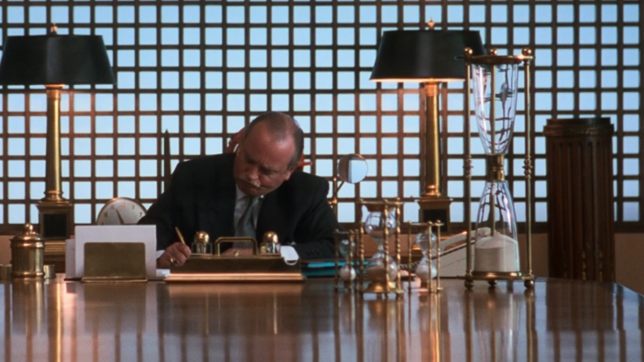 Mr. Shirley t his desk in Christmas Vacation