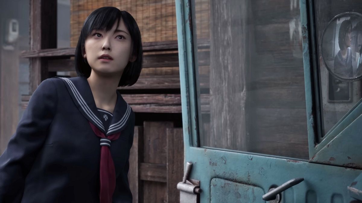 A screenshot from the Silent Hill F reveal trailer, showing a Japanese girl in a school uniform next to a truck