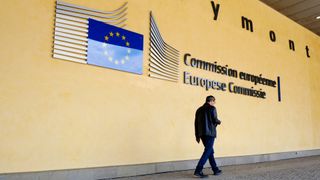 Pedestrian walks outside of the European Commission's building in Brussels, Belgium.