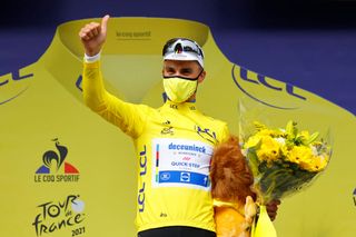 Team Deceuninck Quicksteps Julian Alaphilippe of France celebrates his overall leaders yellow jersey on the podium at the end of the 1st stage of the 108th edition of the Tour de France cycling race 197 km between Brest and Landerneau on June 26 2021 Photo by Thomas SAMSON POOL AFP Photo by THOMAS SAMSONPOOLAFP via Getty Images