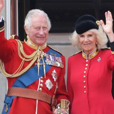King Charles and Queen Camilla wave from Buckingham Palace balcony