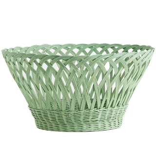 a beautiful open-top pastel green rattan storage basket which is circular in shape