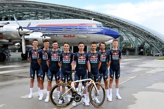 SALZBURG AUSTRIA JUNE 26 LR Bob Jungels of Luxembourg Danny van Poppel of Netherlands Nico Denz of Germany Jai Hindley of Australia Primoz Roglic of Slovenia Matteo Sobrero of Italy Marco Haller of Austria and Aleksandr Vlasov of Russia and Team Red Bull BORA hansgrohe pose for a photograph with the new Specialized bike with Douglas DC6B aircraft in the background during the Official launch Team Red Bull BORA hansgrohe in Red Bull Hangar7 on June 26 2024 in Salzburg Austria Photo by Tim de WaeleGetty Images