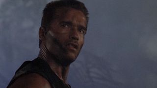 Arnold Schwarzenegger stands in a foggy jungle in Predator