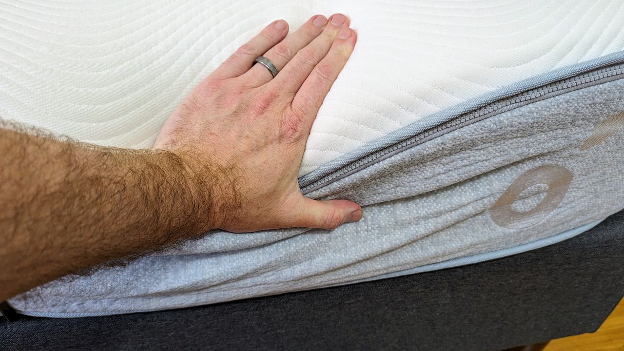 Koala mattress mattress with hand pressing down to show edge support