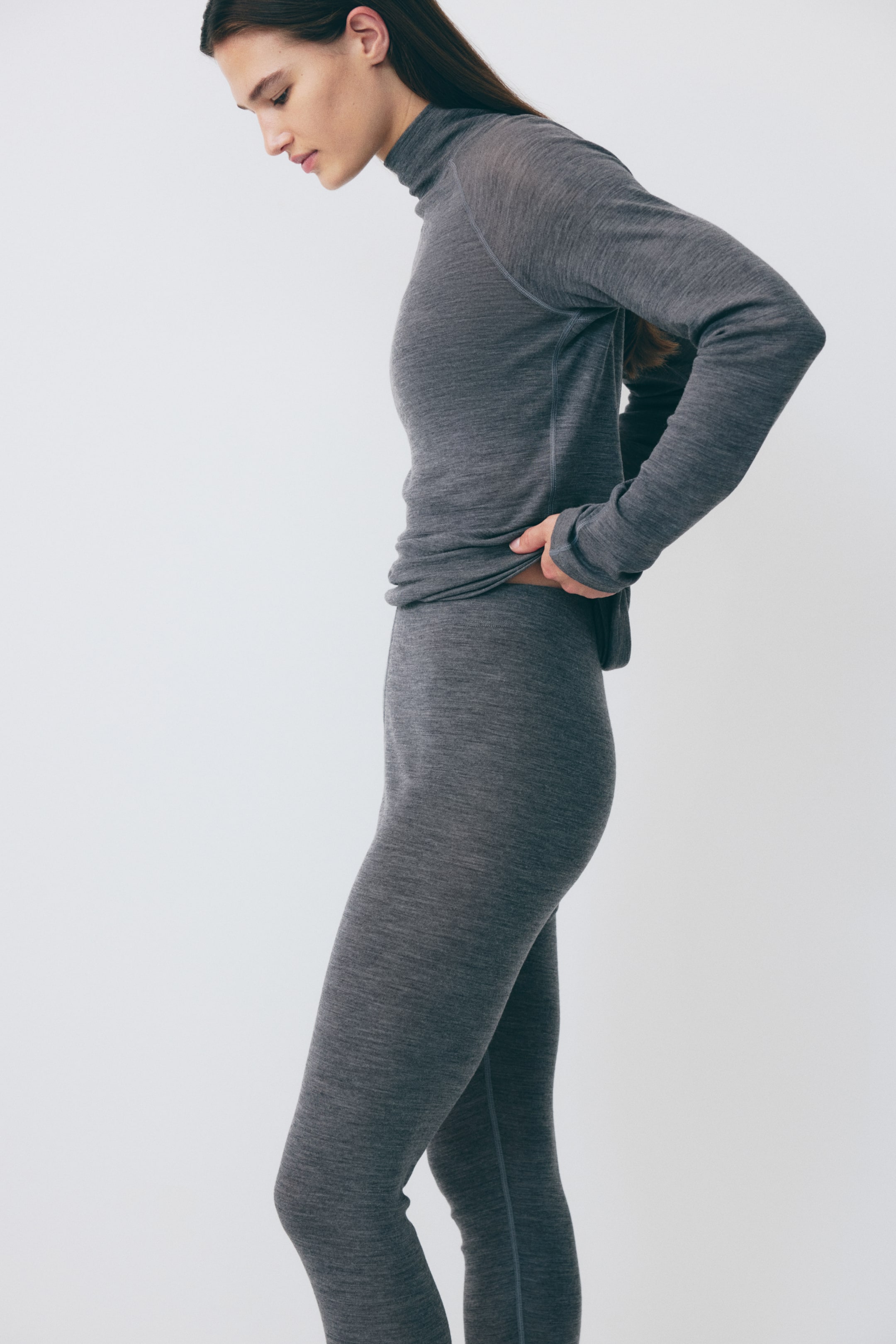 a model wearing grey wool thermal skiing layers