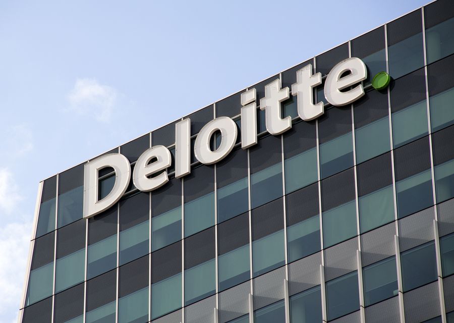 Deloitte sign on the side of an office building