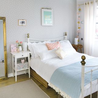 bedroom with blue wallpaper and wooden floor