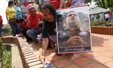 A woman hold a portrait of the late President Hugo Chavez during a ceremony at the Bolivar square, in Barinas, March 8.