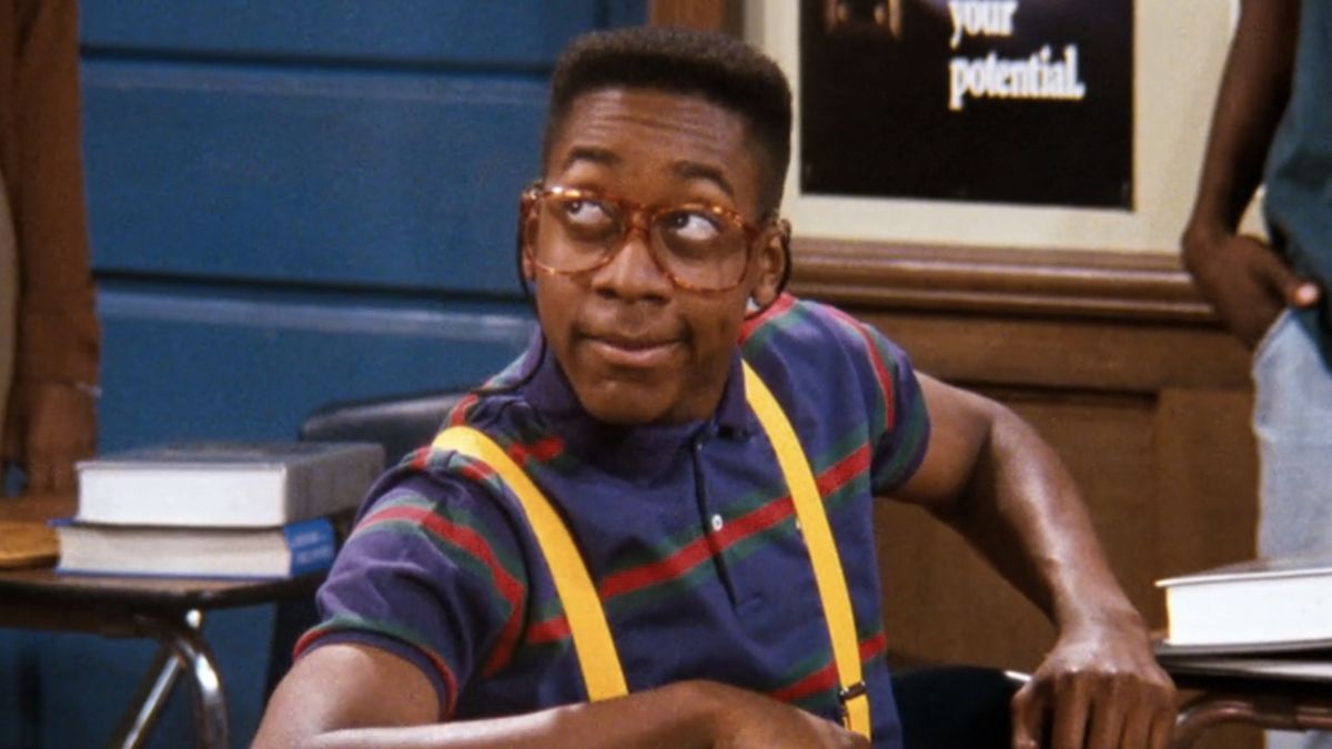 Jaleel White as Steve Urkel sitting at his desk in Family Matters.