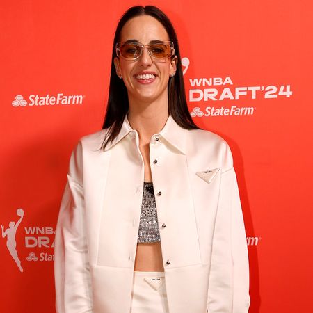 Caitlin Clark wearing a Prada white satin set and black accessories at the 2024 WNBA Draft.