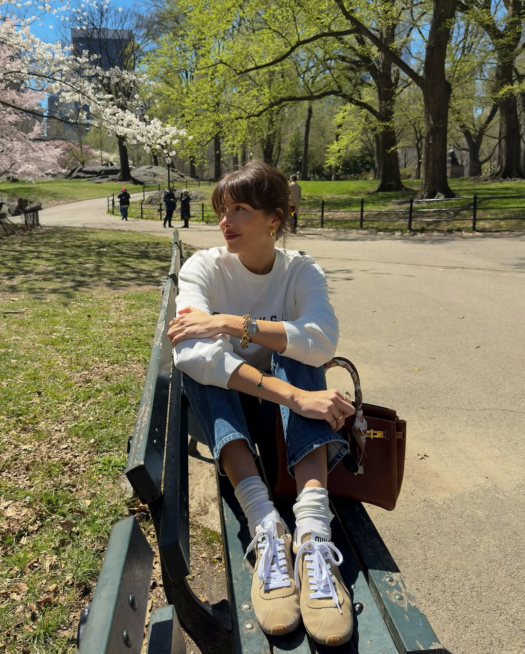 French trainer trends 2025: @juliesfi wears beige trainers from Miu Miu