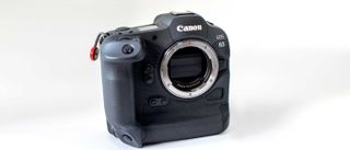 Canon EOS R3 camera photographed during testing on a white background