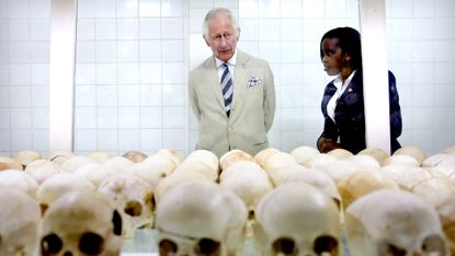Prince Charles is shown skulls during a visit to the Nyamata Church genocide memorial