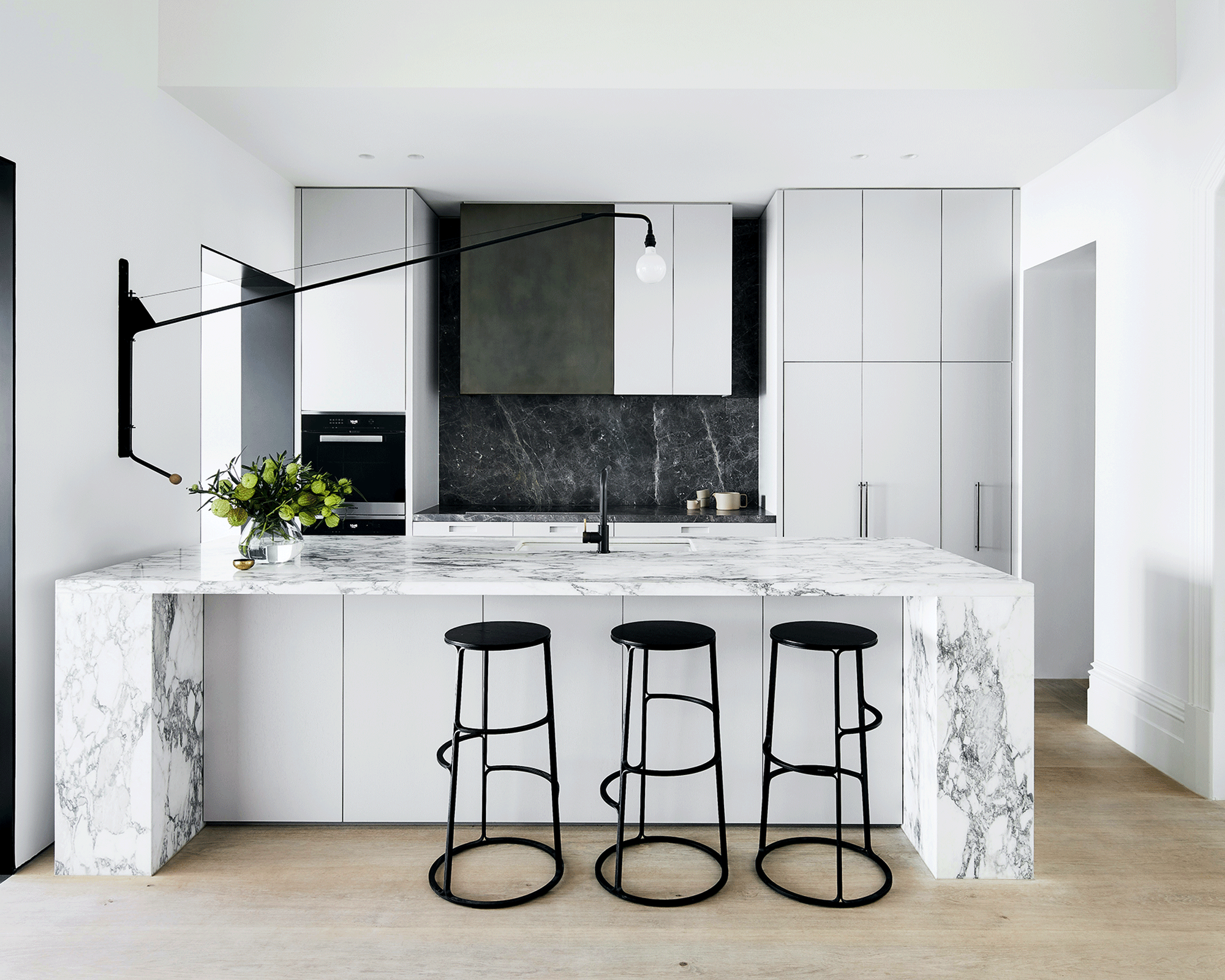 Kitchen with oversized wall light over the island