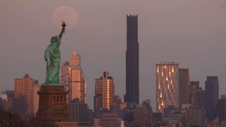 A photo of the 'blood moon' hovering above the Statue of Liberty in New York.