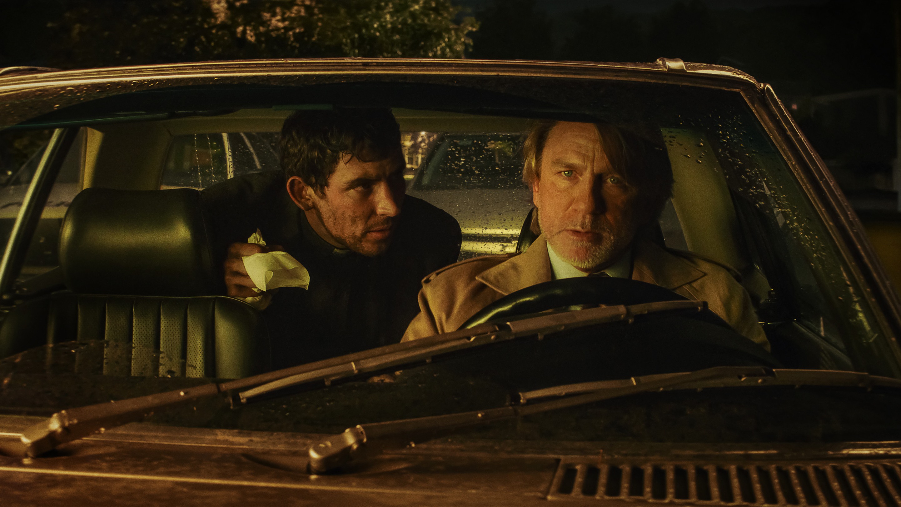 L-R: Josh O'Connor and Benoit Blanc (Daniel Craig) inside a car in a scene from "Wake Up Dead Man: A Knives Out Mystery"