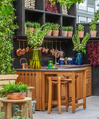 outdoor kitchen by Gaze Burvill with shelves and potted herbs