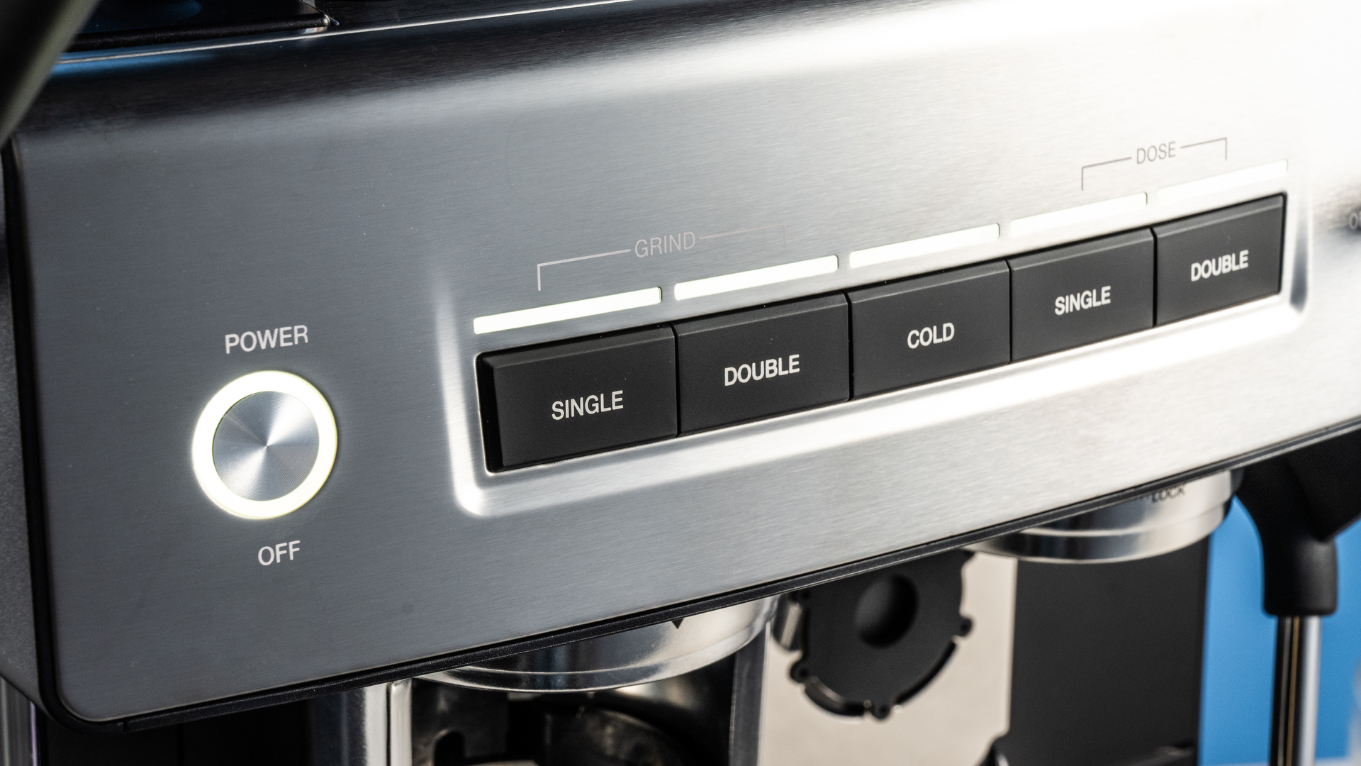 the cuisinart grind, tamp and brew espresso machine with built-in grinder photographed against a blue tom's guide background