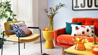 a living room with colourful seating and plants