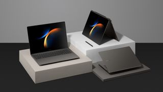 Three Samsung Galaxy Book 3 laptops sitting on some boxes