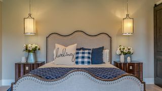 A bedroom featuring two hanging lamps