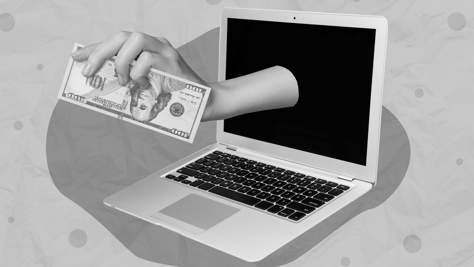 Hand coming through laptop holding cash