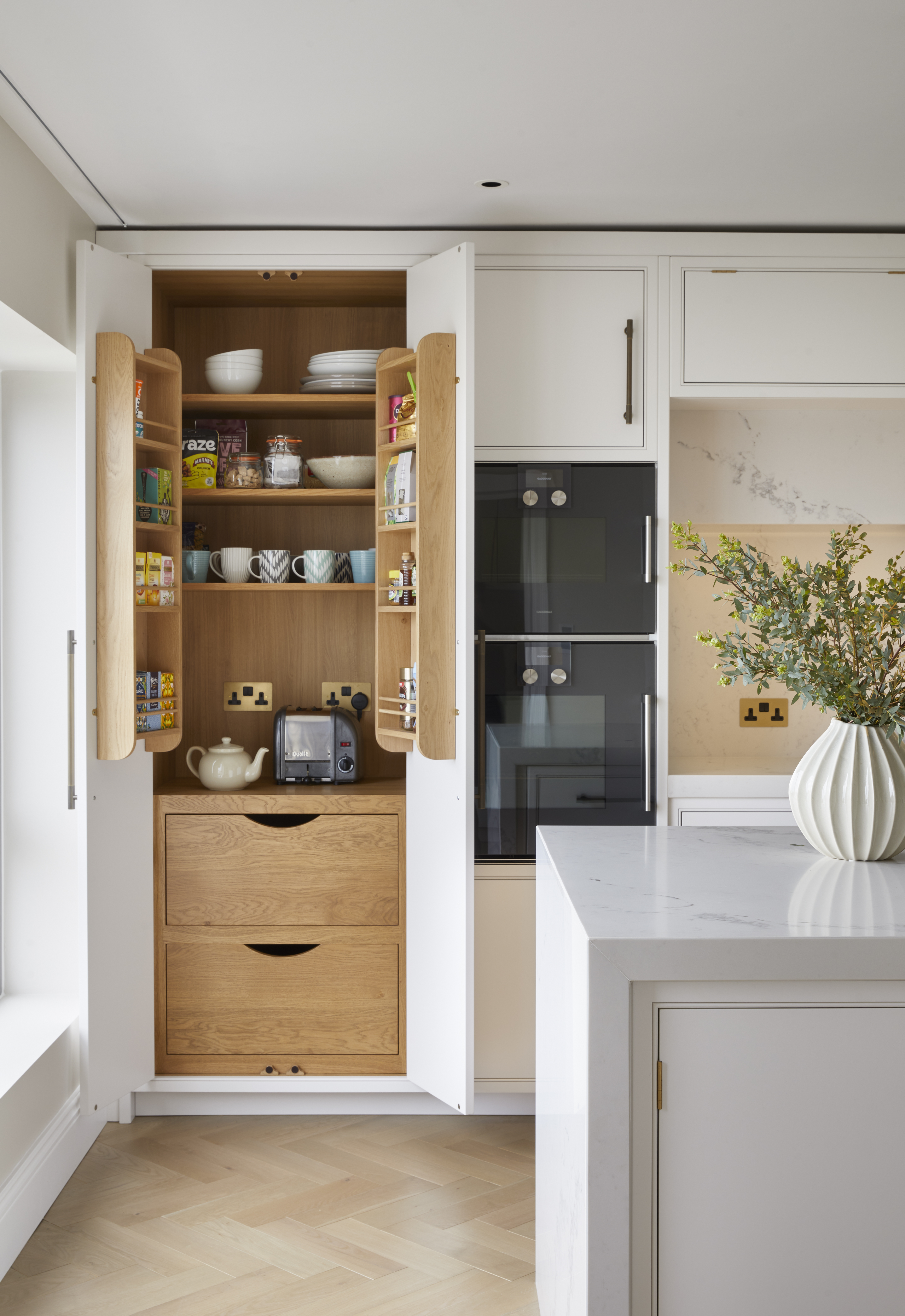 a white matte kitchen with a wooden breakfast bar cabinet