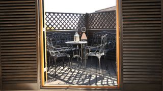 Small patio surrounded by fence with trellis