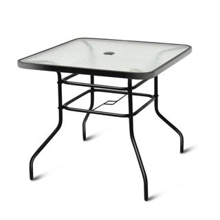 A square metal patio table with a glass top